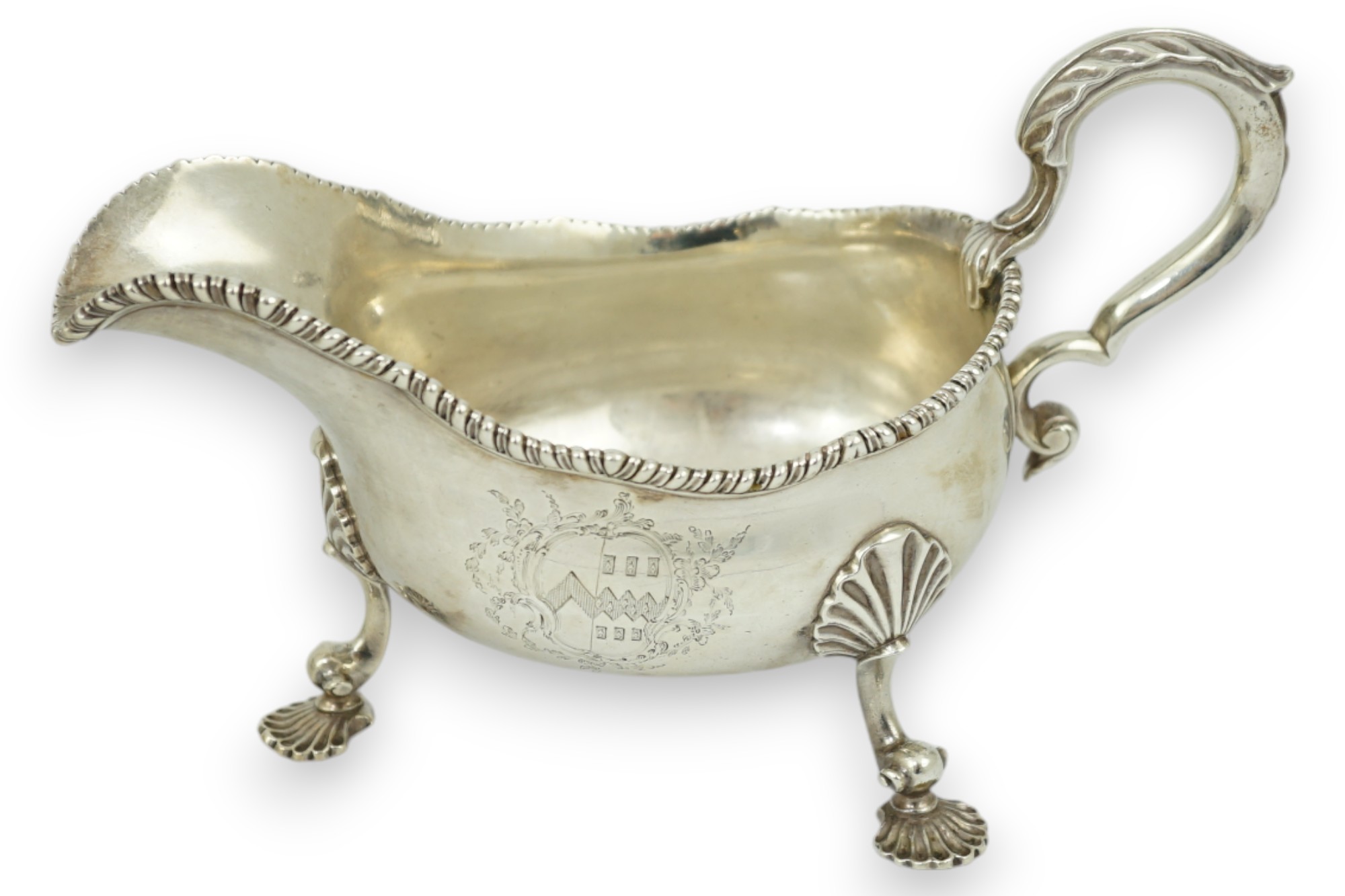 A George III silver sauce boat, with gadrooned border and shell knees, on fluted feet, Francis Crump, London, 1770, length 20.8cm, 13.9oz.